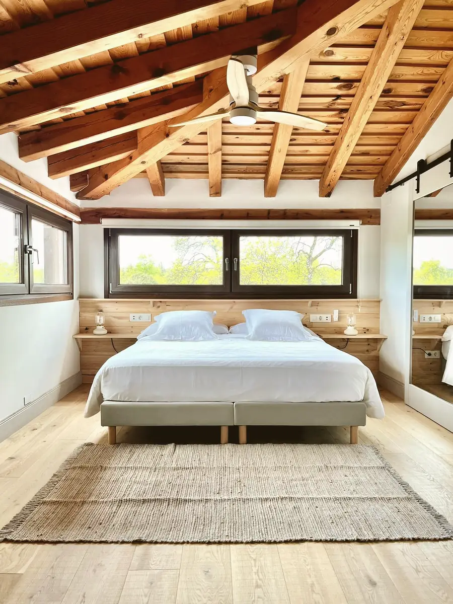 A room with wooden beams looking onto the countryside