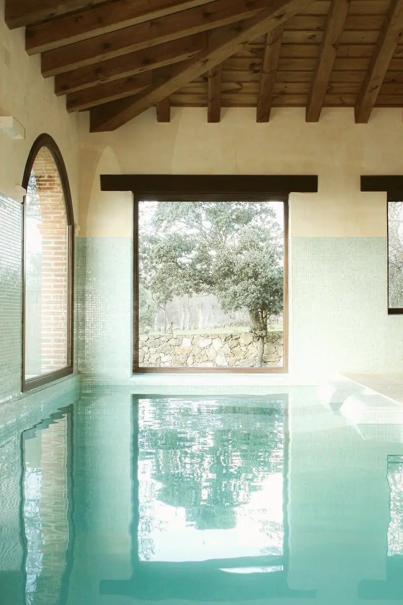 Indoor pool with a window onto the dehesa